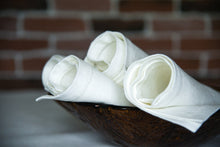 Ielādēt attēlu galerijas skatītājā, Bring classic beauty to your meals with these white linen dinner napkins crafted from premium European linen. Each napkin measures 17×17 in (43×43 cm) and features an understated yet refined hemstitched finish — an elegant detail that frames your place setting with craftsmanship and care.