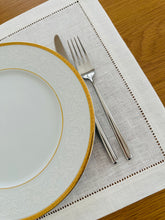 Load image into Gallery viewer, Bring quiet, botanical elegance to your table with these linen place mats embroidered with lily of the valley. Made from natural European linen, they protect surfaces beautifully while adding a refined spring-floral detail. Perfect for coffee moments, hosting, and thoughtful gifting.