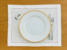 Load image into Gallery viewer, Bring quiet, botanical elegance to your table with these linen place mats embroidered with lily of the valley. Made from natural European linen, they protect surfaces beautifully while adding a refined spring-floral detail. Perfect for coffee moments, hosting, and thoughtful gifting.
