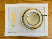 Ielādēt attēlu galerijas skatītājā, white linen placemats with machine‑embroidered meadow wildflowers motifs and hemstitched edges - perfect eco table linens for botanical dining; hostess gifts.