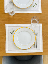 Load image into Gallery viewer, Bring quiet, botanical elegance to your table with these linen place mats embroidered with lily of the valley. Made from natural European linen, they protect surfaces beautifully while adding a refined spring-floral detail. Perfect for coffee moments, hosting, and thoughtful gifting.