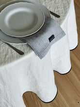 Load image into Gallery viewer, Create and enjoy beautiful moments on holidays and every day with our classic linen collection for table setting.
Round linen tablecloth with tailored black ribbon edge.
Washed linen round tablecloth.
Color: Moonlight white (Off White).
Composition: 100% linen, weight g/m2: 190 +/-20.