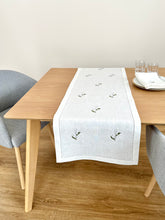 Load image into Gallery viewer, White linen table runner, delicately embroidered with lily of the valley flowers 
