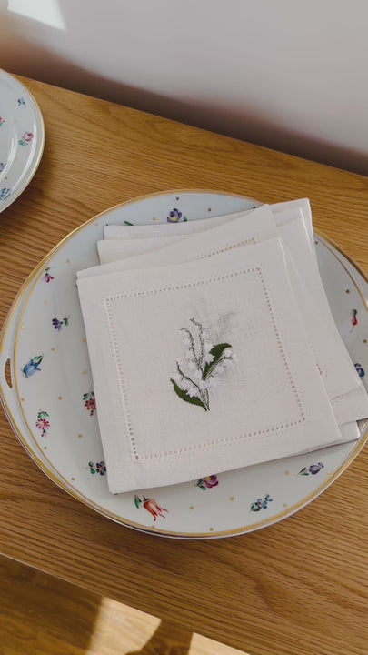 Bring quiet, botanical elegance to your table with these linen coasters embroidered with lily of the valley. Made from natural European linen, they protect surfaces beautifully while adding a refined spring-floral detail. Perfect for coffee moments, hosting, and thoughtful gifting.