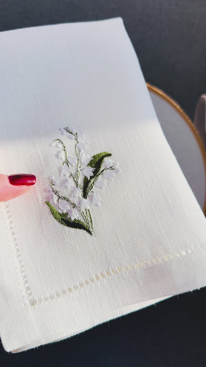 A thoughtful and elegant gift for someone who loves beautifully set tables and meaningful floral details.
Add soft floral elegance to your table with these off-white linen dinner napkins, delicately embroidered with lily of the valley flowers in one corner. Known for their symbolism of purity, renewal, and quiet beauty, lily of the valley motifs bring a gentle, sophisticated accent to both everyday meals and special occasions.