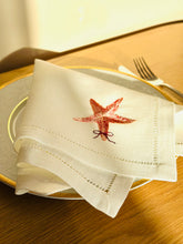 Ielādēt attēlu galerijas skatītājā, Linen Napkin with starfish design embroidery on a plate with cutlery
